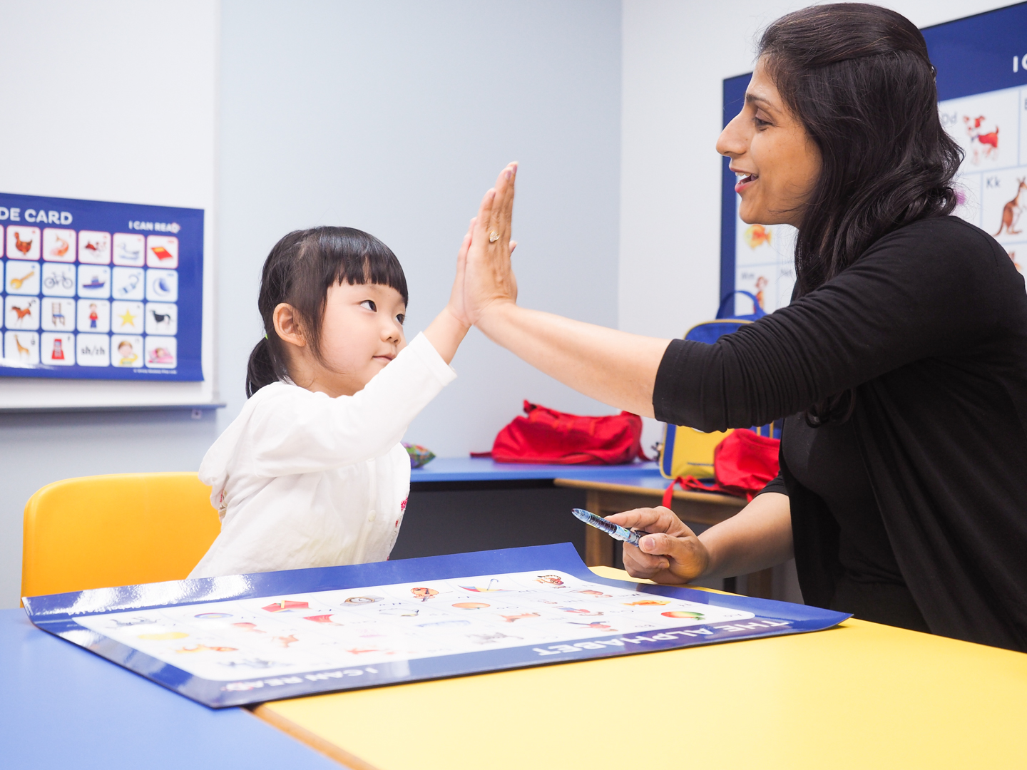 I Can Read Teacher encouraging her student during reading class 